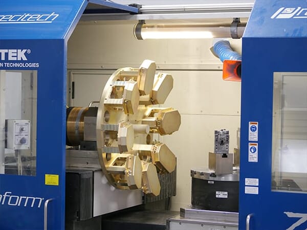 Single-point diamond turning machine creating precision aspheric optical surfaces on infrared materials