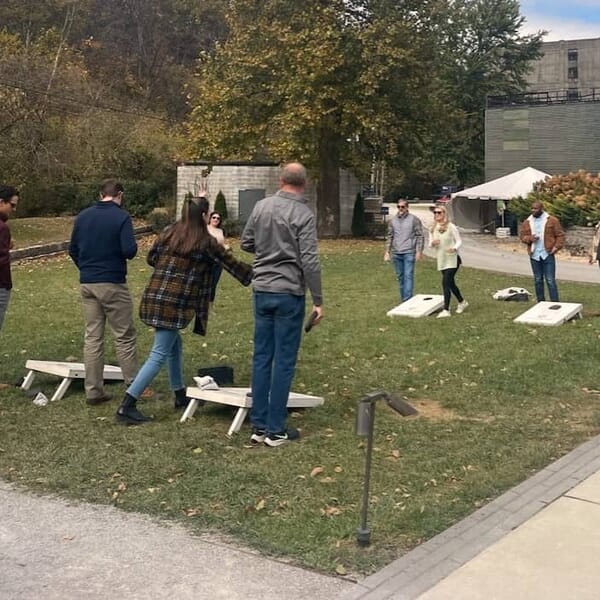 Team cornhole tournament during Cahaba Wealth firm retreat