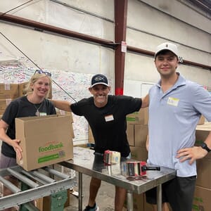Birmingham team members supporting the Community Food Bank of Central Alabama by assembling boxes for their Mobile Pantry & Family Market Programs