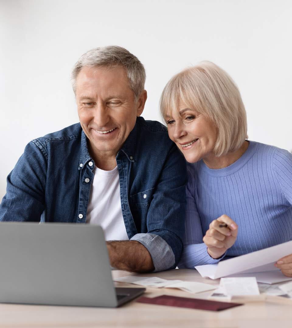 Happy senior couple using a laptop