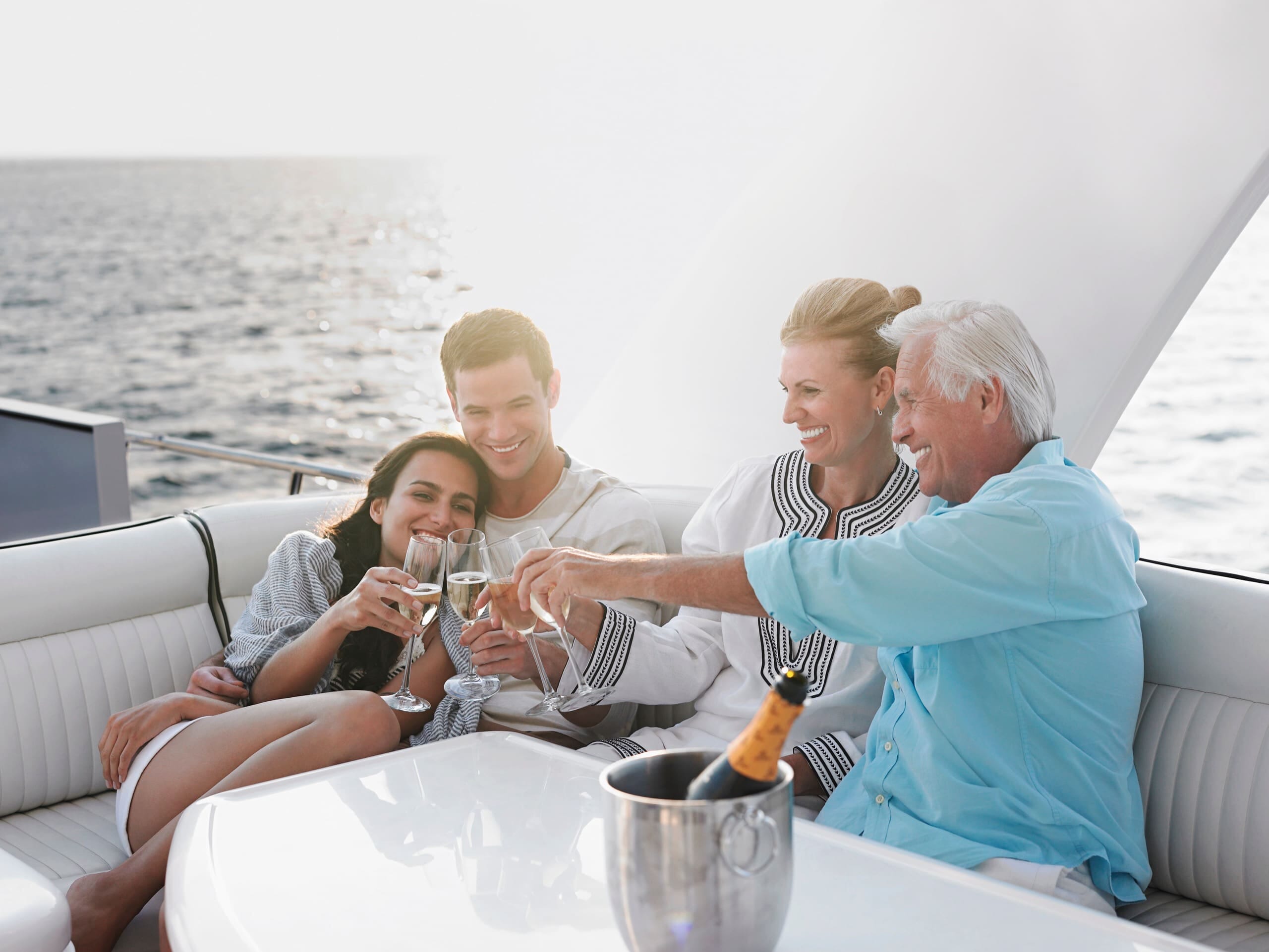 Wealthy family toasting with champagne on a boat