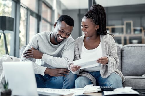 Happy couple using a laptop