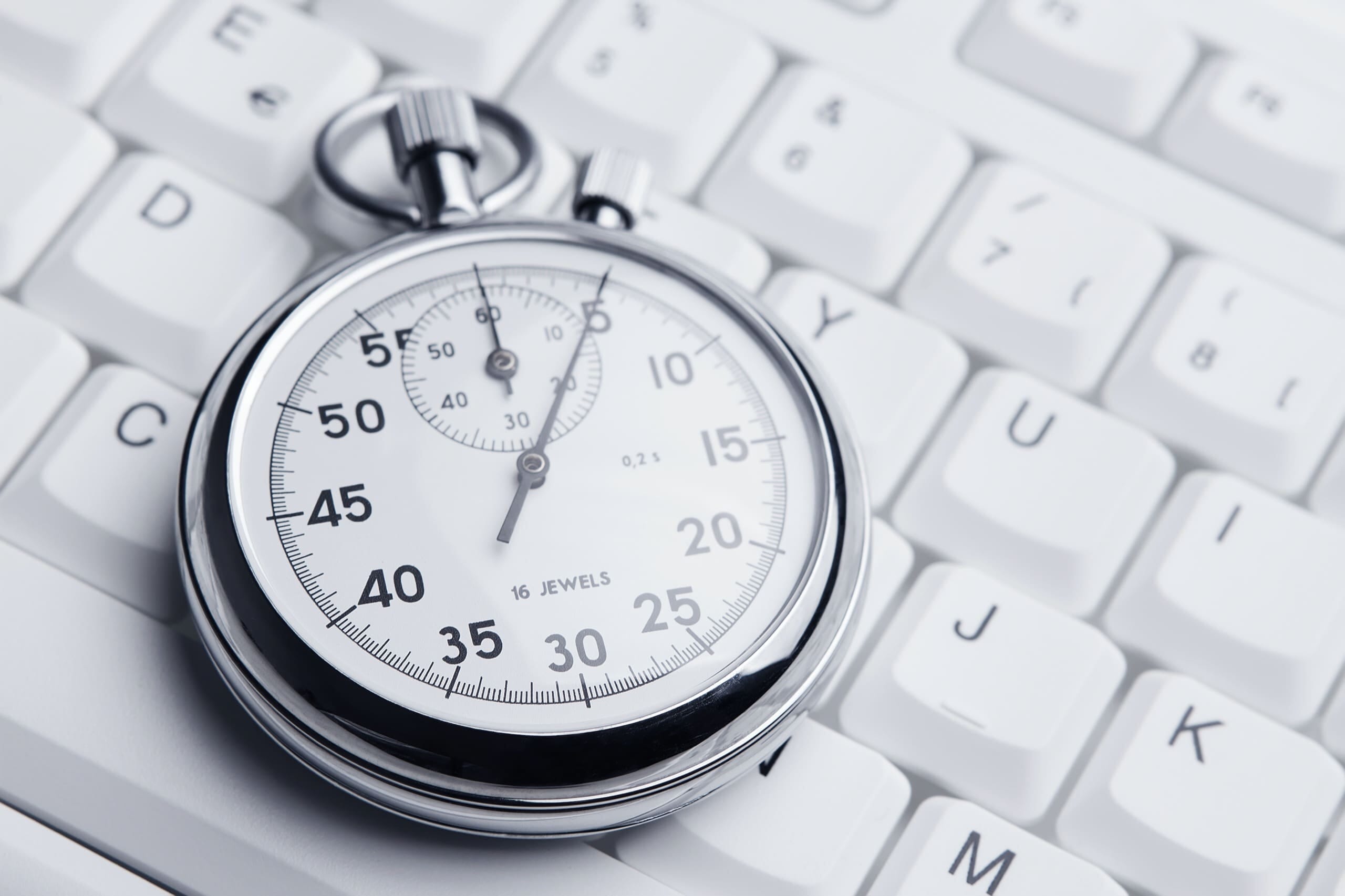 Stopwatch on a white computer keyboard