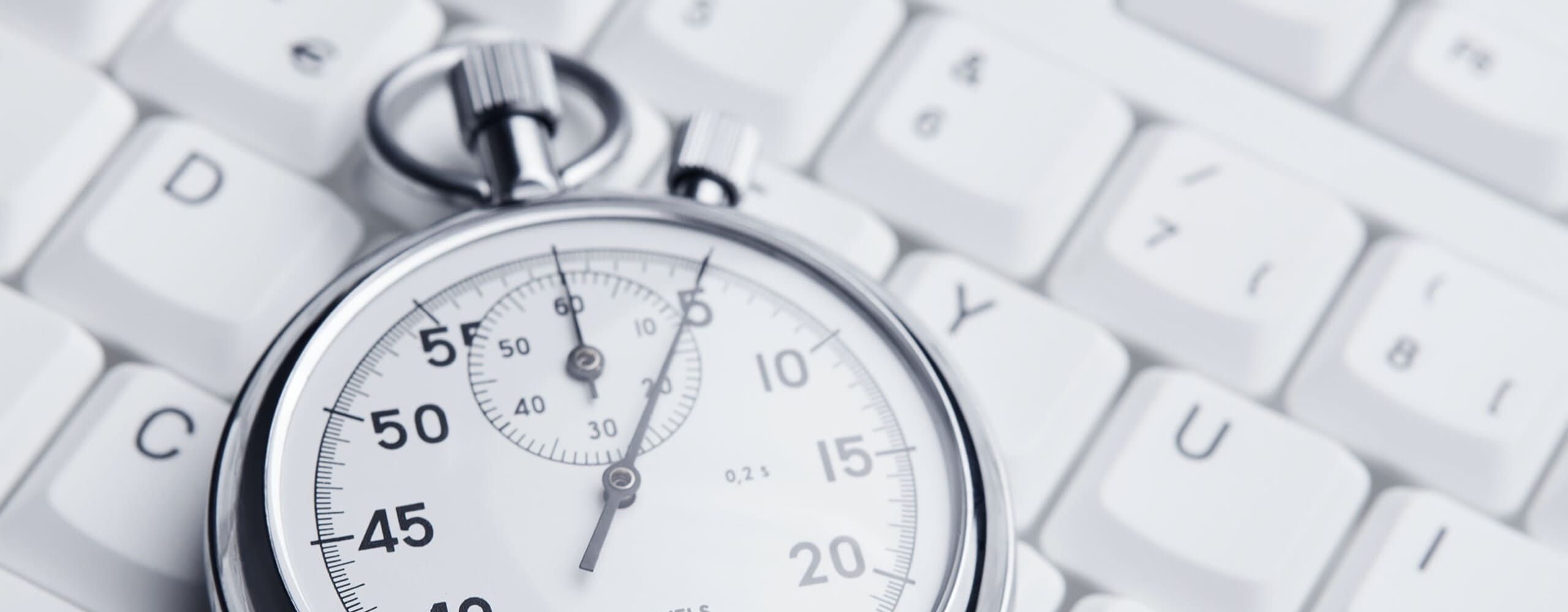 Stopwatch on a white computer keyboard