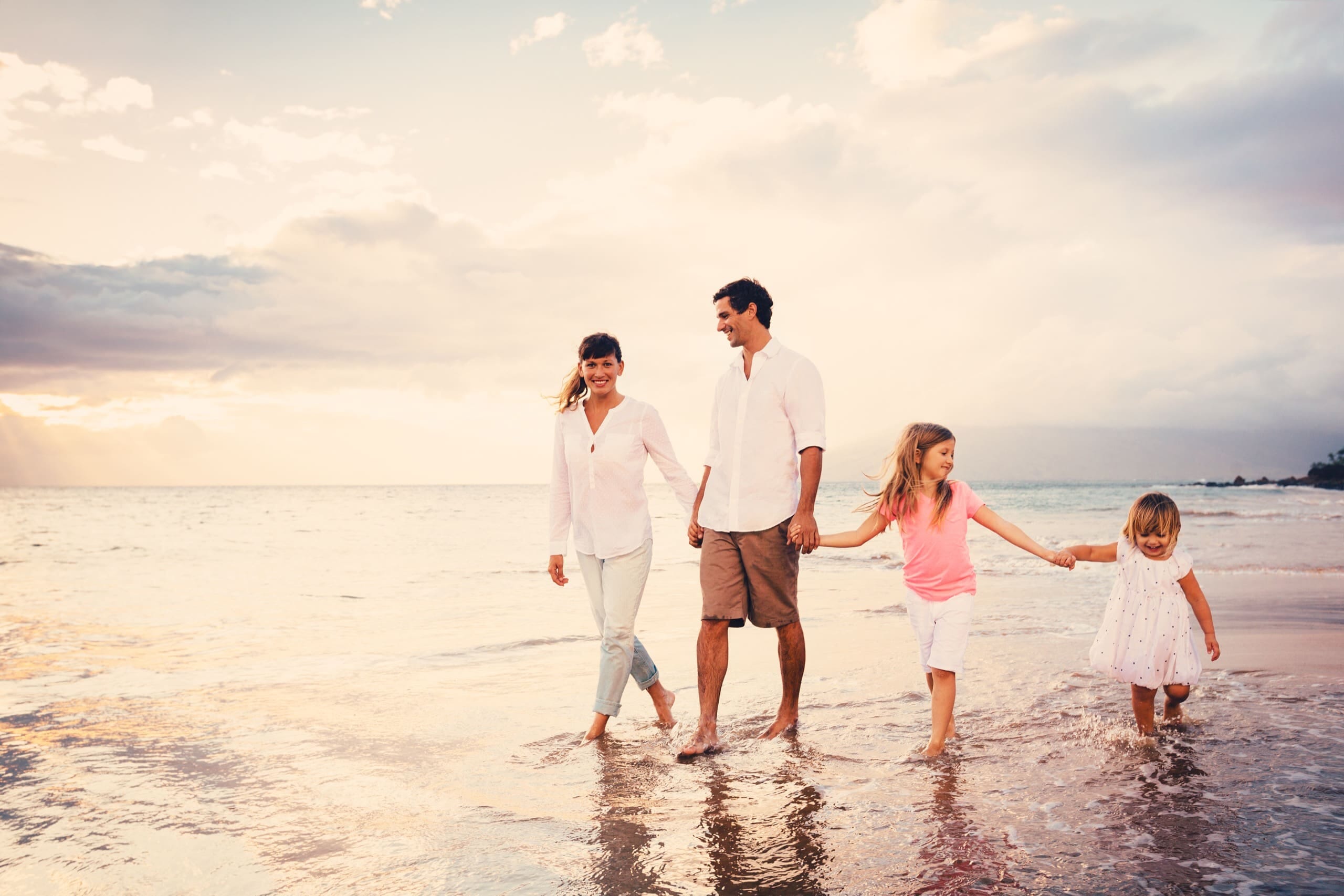 Young family walking on the beach