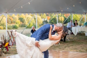 Maine newlywed couple kissing under a tent in fall