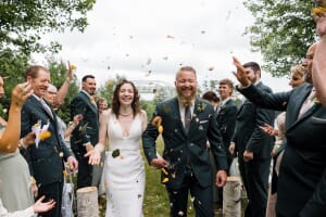 Maine newlyweds with crowd throwing dried flowers